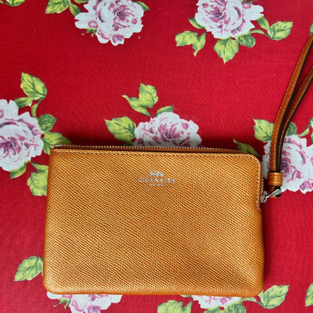 COACH tangerine metallic wristlet